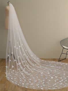 a wedding veil with white butterflies on it