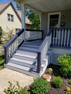 a porch with steps leading up to the front door