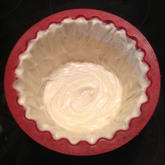 a red and white pie dish on top of a stove