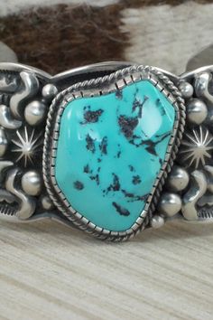 This Sleeping Beauty turquoise and sterling silver bracelet was made by Navajo silversmith Roland Dixson. The inside is signed and stamped sterling.Size: 5 3/4" (will fit up to a 7 1/4" wrist)Gap: 1 1/2"Width: 1 1/2"Free shipping on all orders! We ship with USPS and always include tracking. All orders ship within a day of payment.Returns are accepted up to 30 days after you receive your order. Just send us a message. Our shop offers cash back or store credit. The item must be returned in new con Southwestern Style Turquoise Bracelet Stamped 925, Turquoise Sterling Silver Bracelet With Patina, Artisan Sterling Silver Turquoise Bracelet Collectible, Western Style Blue Sterling Silver Bracelet Gift, Western Style Sterling Silver Bracelets, Southwestern Style Stamped Turquoise Bracelets, Western Turquoise Bracelet With Patina, Southwestern Style Turquoise Stamped Bracelets, Western Sterling Silver Bracelets