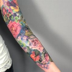 a woman's arm with flowers painted on it