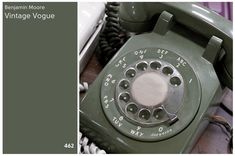 an old green telephone sitting on top of a table