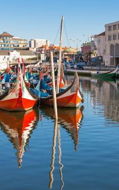 there are many boats that are docked in the water near each other and some buildings