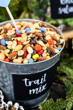 a bucket full of trail mix with an arrow sticking out of it's top