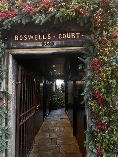 the entrance to boswell's court is decorated for christmas