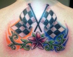 the back of a man's chest with checkered flags and flowers on it