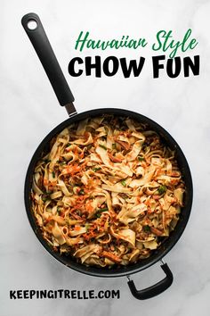 a skillet with noodles and carrots in it on a white table next to the words hawaiian style chow fun