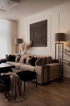 a living room filled with lots of furniture next to a large window and floor lamp