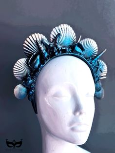 Yet another attempt at capturing the beauty of the ocean with our mermaid crown, crafted from an exquisite selection of seashells and inspired by the wonder of the sea. Handcrafted in deep ocean blues and shimmering black highlights, this seashell headband is for any sea-loving mermaid looking to add a touch of mystical magic to their look. 



Color - Deep Blue hues and black shimmer highlights


Age Group/Gender - 
Fits ages 10 and up & Adults Unisex

Material - Headband with sea shells and pa Material Headband, Seashell Headband, Mermaid Headpiece, Seashell Crown, Ocean Mermaid, Mermaid Crown, Black Highlights, Deep Ocean, Masks Masquerade