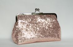 NOTE: ALL OF MY BAGS ARE HANDMADE TO CUSTOMERS INDIVIDUAL ORDERS!! Gorgeous and Elegant. A beautiful handmade Rose Gold sequin clutch purse, fully lined with pink satin fabric. Reinforced with heavy weight interlining and interfacing so it maintains its shape. All stress points have been double stitched for durability. The size is perfect to carry your essentials for a day or night out, i.e mobile phones, keys, make-up, credit cards and coins. The purse as well as many others in my collection wo Bridal Bags, Bridal Clutch Purse, Pink Satin Fabric, Gold Sequin Fabric, Wedding Clutch Purse, Silk Clutch, Bridesmaid Clutches, Clutch Bag Wedding, Sequin Clutch