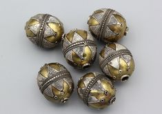 Beautiful 6 pcs Turkoman Kazakh Style Ethnic Tribal Silver & Bronze Beads. The Beads are 100% hand crafted with beautiful silver wire and partial gold wash gold gilded workmanship. Quantity of Beads : 6 pcs Beads Bead Size : 26 x 21mm. Drill Hole size: Approx. 3.5mm Weight: Approx. 5.5 grams (each bead). ★ Real colors may vary slightly due to different color adjustment of screens. Thanks for taking the time to look and please contact for further pictures or info. Traditional Oval Jewelry With Large Beads, Artisan Silver Oval Beads, Traditional Oval Handmade Beads, Oval Traditional Beads For Jewelry Making, Handmade Silver Oval Beads, Kazakh Style, Oval Beads, Gold Wash, Gold Gilding