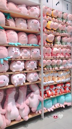 many pink and blue pig figurines are on shelves