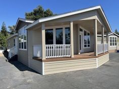 a mobile home sits in a parking lot with lots of windows and balconies