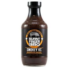 a bottle of smokey bbq barbecue sauce sitting on a white surface with the label burnt finger bbq