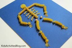 an image of some food that is made to look like human legs and arms on a blue mat