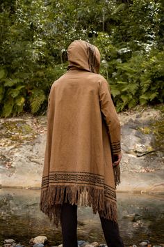 Our JUBBA cloak is a hybridised combination of a jacket, poncho, cloak and robe . . . it has a large hood, long sleeve and a pocket . . . can be worn open or closed with a coconut button on the shoulder . . . JUBBA is made of 100% naturally dyed and block printed cotton . . . Inspired by the post-apocalyptic dune-like dystopian clothing styles, JUBBA is designed for festivals and walkabouts . . . Measurements: Length: 91 cm / 35.8 inches Shoulder sleeve length: 64 cm / 25.1 inches Underarm sleev Poncho Cloak, Mens Kimono Jacket, Ritual Clothing, Mens Poncho, Male Kimono, Viking Clothing, Poncho Jacket, Hemp Clothing, Festival Pants