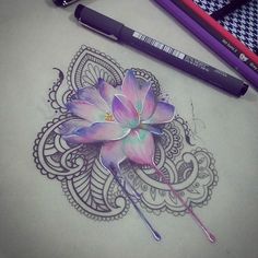 a drawing of a flower on paper with colored pencils next to it and two markers