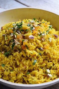 a white bowl filled with rice and vegetables