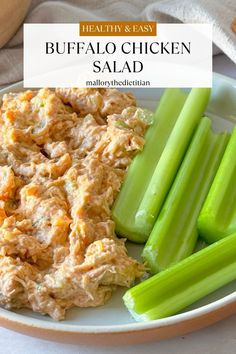 buffalo chicken salad on a white plate with celery sticks and bread in the background