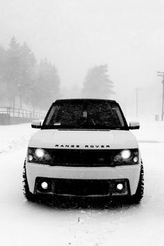 a white truck driving down a snow covered road