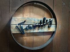 a wooden sign that says welcome hanging on the side of a wood wall next to a barrel