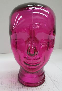 a pink plastic skull head sitting on top of a table