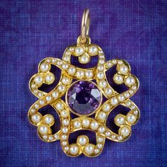 "A pretty antique Victorian pendant made by London jewellers \"Gresham Barber & Co\" in the early 20th century. The piece is fashioned in 15ct gold with a fabulous overlapping design decorated with pearls and a bezel set amethyst in the centre weighing approx. 1.60ct. It's in excellent condition and complete with its original fitted box to store it in with the maker's logo displayed on top. We recommend you insure for £1,600. We can provide a written Valuation on completion of the sale. WEIGHT: Art Nouveau Jewelry With Historical Design For Gift, Art Nouveau Jewelry With Historical Design As Gift, Antique Engraved Purple Jewelry, Victorian Jewelry With Historical Design For Anniversary, Victorian Jewelry For Anniversary With Historical Design, Collectible Victorian Jewelry With Historical Design, Victorian Baroque Yellow Gold Jewelry, Victorian Baroque Collectible Jewelry, Victorian Jewelry With Historical Design As Gift