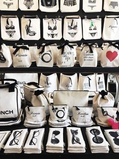 many bags are on display in front of the store's wall displaying their designs