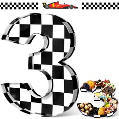 the number three is made out of black and white checkered paper with different foods on it