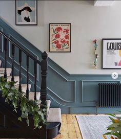 the stairs are painted blue and have pictures on them, along with potted plants