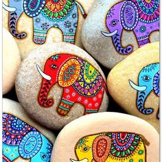 some rocks with painted elephants on them