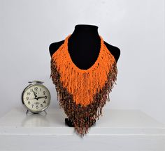 Unique African Maasai Handcrafted Beaded Necklace with an Elegant Look and Brilliant Finish. Circumference = 16 Inches/ 41 Centimeters. Color =Orange and Multi-Color Maasai Beads. Fringe = 10 Inches / 26 Centimeters. **GET FREE SHIPPING FOR ADDITIONAL ITEMS PURCHASED. Yes, Buy Multiple Items and pay shipping for 1 item only- The rest ships Free. (No Limits on the number of Multiple items). With a faster delivery time of 3 days via DHLExpress, Worldwide. Ordinary/Standard Shipping also available Traditional Orange Necklace For The Beach, Festival Orange Large Beaded Necklaces, Orange Large Beaded Necklace For Festivals, Festival Orange Large Beaded Necklace, Festival Orange Large Beads Necklace, Bohemian Beaded Chain, Bohemian Beaded Chain Beads, Orange Beaded Bohemian Choker, Orange Bohemian Beaded Choker