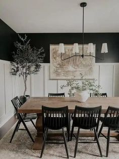 a dining room with black chairs and a wooden table