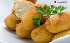 some fried food on a white plate with parsley