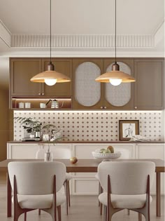 a dining room table with four chairs and two lights hanging from it's ceiling