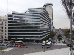 an aerial view of a large building with many windows and cars parked in the parking lot