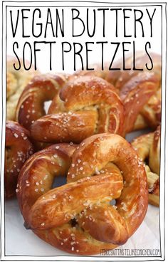 there are many soft pretzels with sesame seeds on them and the words, vegan buttery soft pretzels