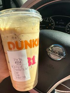 a dunkin'donuts drink in a car