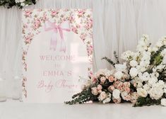 a welcome sign next to flowers and candles