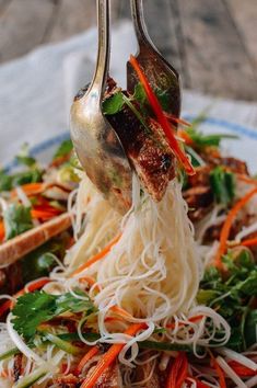 a plate topped with meat and veggies covered in sauce