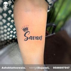 a woman with a crown tattoo on her arm that says savan in cursive font