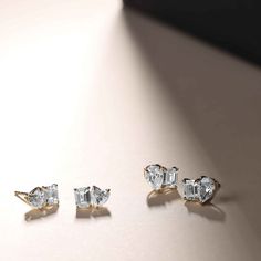 Indulge in the extraordinary beauty of this Toi et Moi Studs, where a heart-shaped diamond is lovingly cradled beside an emerald cut. This unique diamond combination sets them apart, making them a conversation starter and a symbol of your refined taste. Destined to be cherished for generations, these earrings are a testament to all those special moments that transcend time. Elegant Heart Cut Baguette Diamond Jewelry, Heart Cut Baguette Diamond Jewelry For Anniversary, Anniversary Heart Cut Baguette Diamond Jewelry, Replica Jewelry, Shimmer And Shine, Shimmer N Shine, Vs Diamond, Heart Shaped Diamond, Stone Studs