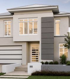 a two story house with white and gray sidings