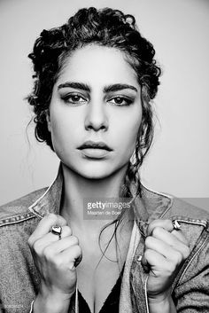 black and white photo of a woman with braids on her hair, wearing a denim jacket