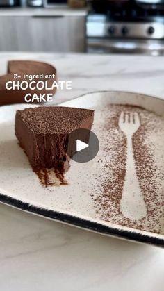 a piece of chocolate cake sitting on top of a plate with a fork in it