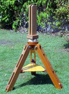 a small wooden tripod in the grass