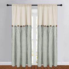 a curtain with buttons on it in front of a window and hardwood flooring area