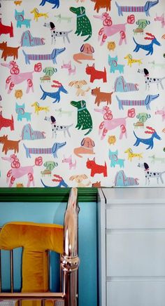 the wall paper is colorful and has dogs on it