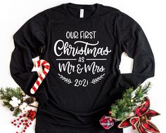 W H A T ' S * I N C L U D E D A super soft, solid black, long sleeve t-shirt with the Our First Christmas As Mr. and Mrs. 2021 shirt design in white. M A T E R I A L S - 100% Airlume combed and ring-spun cotton - High quality heat transfer vinyl S I Z I N G - Unisex sizes. - Please refer to the size chart in the listing pictures for more information. C A R E - Machine wash warm or cold / mild detergent. - Tumble dry low or hang to dry. - Do not use bleach or iron on the design. P R O D U C T I O Engagement Shirt, Preschool Teacher Shirts, Engaged Shirts, Matching Christmas Shirts, Christmas Engagement, Mrs Shirt, Matching Christmas Pajamas, Engagement Gifts For Couples, Christmas Gifts For Couples