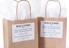 two brown paper bags with welcome tags on them sitting next to each other in front of a white background